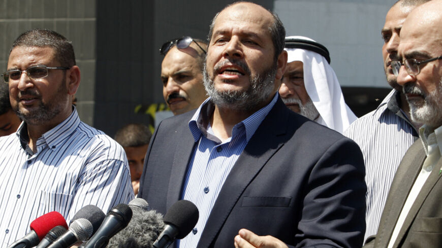 Senior Hamas leader Khalil al-Hayya (C) speaks to the media upon his return to Gaza City from truce talks in Cairo August 14, 2014. A renewed truce between Israel and Hamas appeared to be holding on Thursday despite a shaky start, after both sides agreed to give Egyptian-brokered talks more time to try to end the Gaza war. REUTERS/Ahmed Zakot (GAZA - Tags: POLITICS CIVIL UNREST) - RTR42EMW