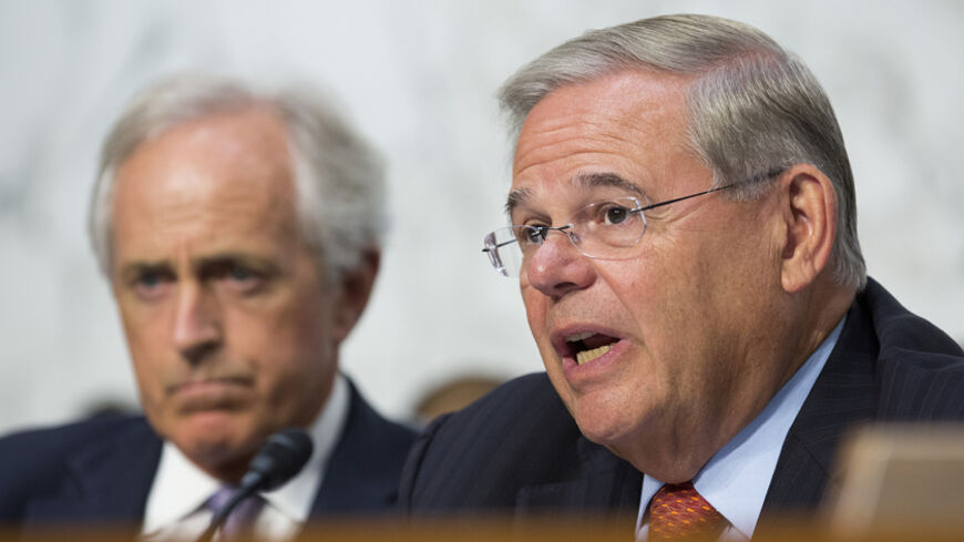 Chairman of the Senate Foreign Affairs Committee Robert Menendez (D-NJ)(R) questions Secretary of State John Kerry as Senator Bob Corker (R-TN) looks on during a hearing on "U.S. Strategy to Defeat the Islamic State in Iraq and the Levant" on Capitol Hill in Washington September 17, 2014.      REUTERS/Joshua Roberts    (UNITED STATES - Tags: POLITICS CIVIL UNREST CONFLICT) - RTR46NIU
