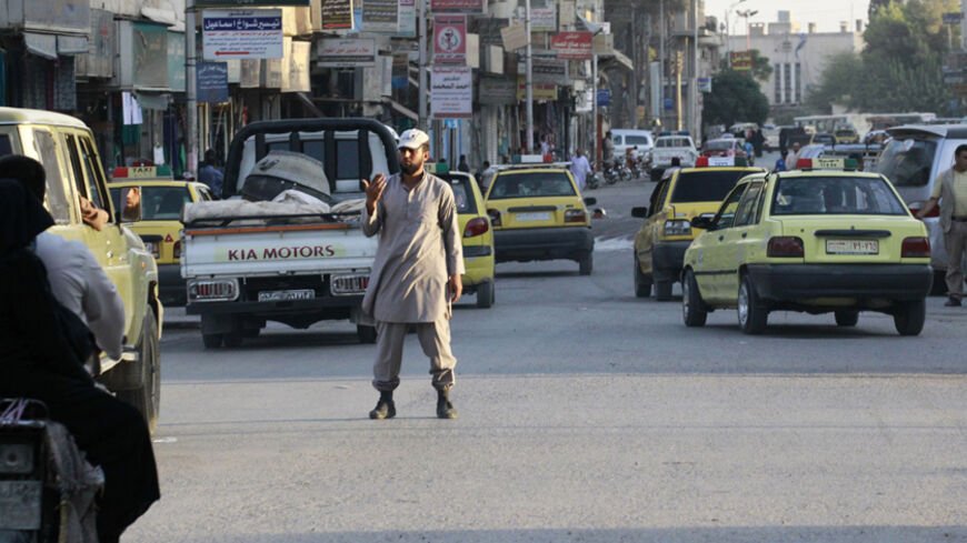 An Islamic State policeman controls traffic in Raqqa September 18, 2014. Picture taken September 18, 2014. REUTERS/Stringer (SYRIA - Tags: TRANSPORT SOCIETY) - RTR46TUK