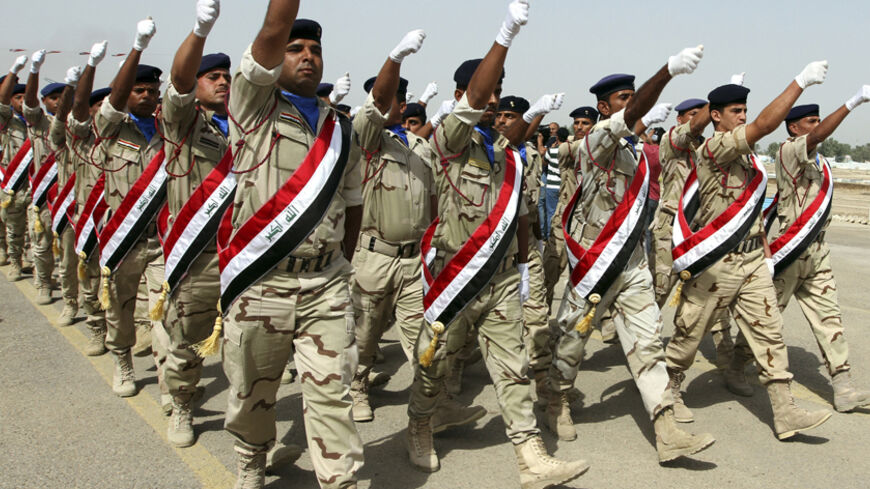 Iraqi Army soldiers march during a parade marking the founding anniversary of the army's artillery section in Baghdad October 1, 2014. REUTERS/Mahmoud Raouf Mahmoud (IRAQ - Tags: MILITARY ANNIVERSARY) - RTR48K2W