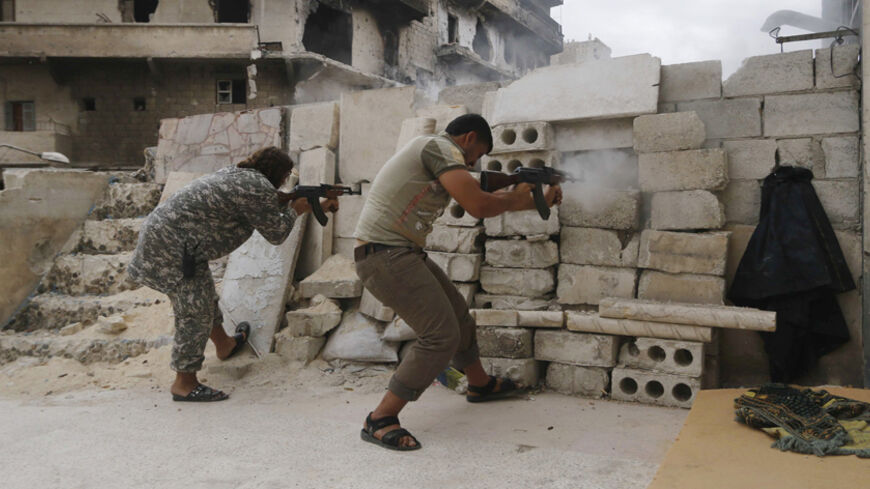 Rebel fighters fire their weapons at the frontline against forces loyal to Syria's President Bashar al-Assad in al-Amriyah neighbourhood of Aleppo October 11, 2014. REUTERS/Hosam Katan    (SYRIA - Tags: POLITICS CIVIL UNREST MILITARY CONFLICT) - RTR49S8W