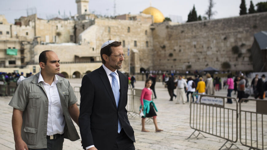 Israeli parliament member from the Likud party Moshe Feiglin (R) walks near the Western Wall after visiting the compound known to Muslims as Noble Sanctuary and to Jews as Temple Mount in Jerusalem's Old City November 2, 2014. Feiglin, a far-right politician who wants Jews to be allowed to pray at Jerusalem's al-Aqsa compound, visited the site on Sunday, defying Prime Minister Benjamin Netanyahu's calls for restraint after clashes this week between Israeli police and Palestinians. REUTERS/Amir Cohen (JERUSA