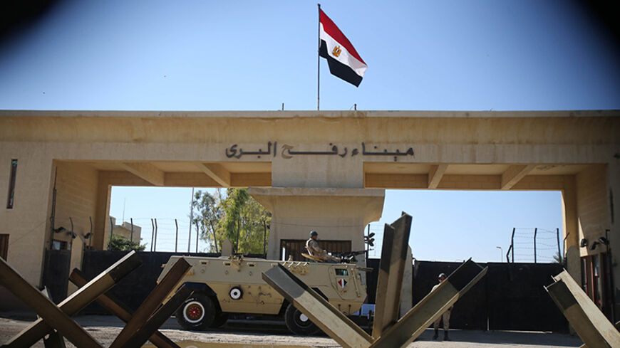 An Egyptian soldier keeps watch at the closed Rafah border crossing, between southern Gaza Strip and Egypt November 6, 2014. At Egypt's border with the Gaza Strip, families are emptying their homes - lugging mattresses and furniture onto waiting vans as soldiers look on from armoured cars. In nine villages along the frontier, 680 houses - homes to 1,165 families - are being razed to seal off smugglers' tunnels and try to crush a militant insurgency in northern Sinai that has intensified since the army overt