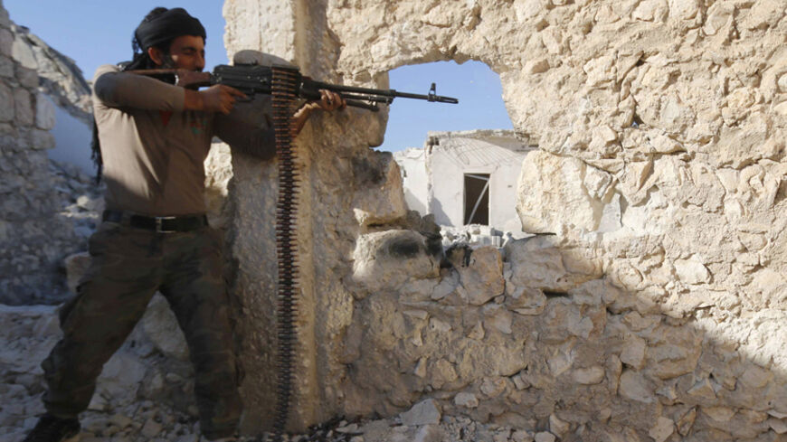 A Free Syrian Army fighter fires his weapon during clashes with forces loyal to Syria's President Bashar al-Assad in the Handarat area, north of Aleppo November 6, 2014. REUTERS/Hosam Katan (SYRIA - Tags: CIVIL UNREST CONFLICT) - RTR4D5F0
