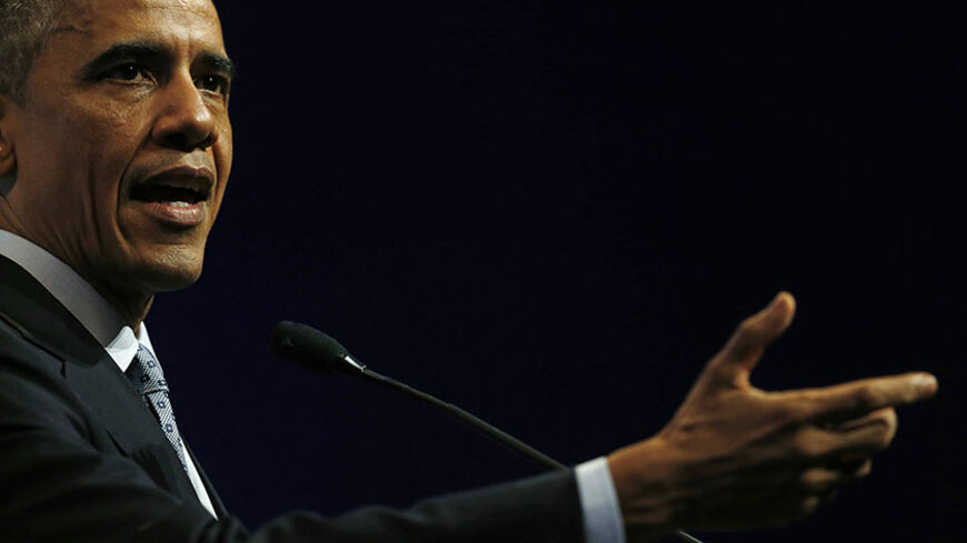 U.S. President Barack Obama speaks at a news conference at the end of the G20 Leaders Summit in Brisbane November 16, 2014. Obama said on Sunday that Russia would remain isolated by the international community if President Vladimir Putin continued to violate international law and treaties aimed at ending the conflict in Ukraine. REUTERS/Jason Reed (AUSTRALIA - Tags: POLITICS BUSINESS) - RTR4EB4N