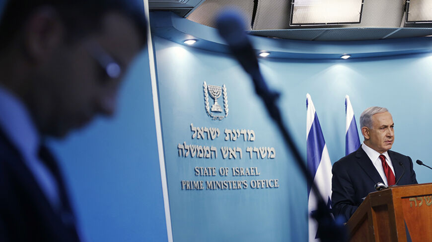Israel's Prime Minister Benjamin Netanyahu delivers a statement to the media in Jerusalem November 18, 2014. Two Palestinians armed with a meat cleaver and a gun killed four worshippers in a Jerusalem synagogue on Tuesday before being shot dead by police, the deadliest such incident in six years in the holy city. Israeli Prime Minister Benjamin Netanyahu pledged to respond with a "heavy hand" and accused Western-backed Palestinian President Mahmoud Abbas of inciting violence in Jerusalem.  REUTERS/Baz Ratne