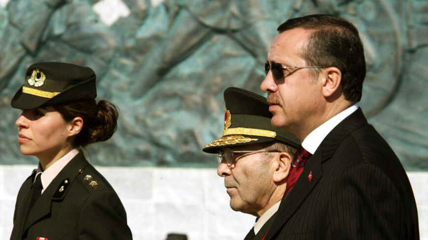 Turkish Prime Minister Tayyip Erdogan and Chief of Staff General Hilmi Ozkok are accompanied by a female officer as thek walk past Turkish memorial in Gallipoli. Turkish Prime Minister Tayyip Erdogan (R) and Chief of Staff General Hilmi Ozkok are accompanied by a female officer as they walk past Turkish memorial in Gallipoli, in western Turkey, March 18, 2005. Turkey marked today the 90th anniversary of the World War One battle which Turkish forces defeated allied forces in Dardanelles straits in 1915, cla