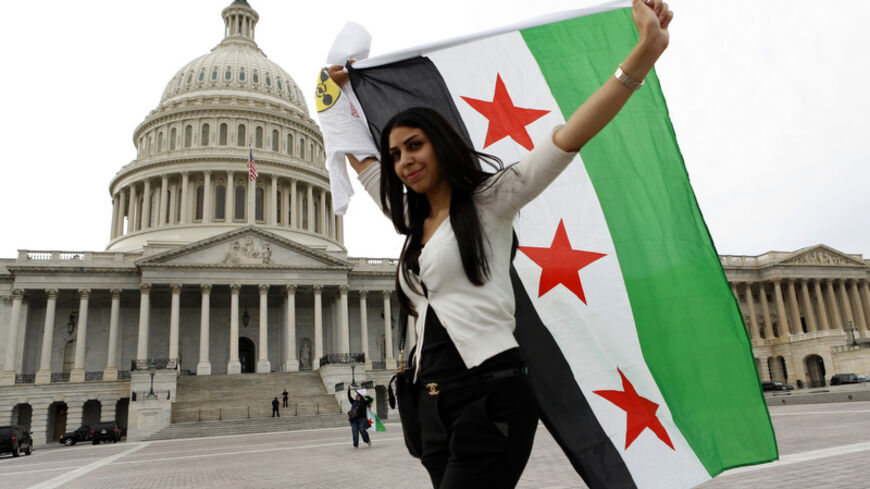 An anti-Assad protester carries the Syrian freedom flag in front of the U.S. Capitol in Washington September 9, 2013. White House efforts to convince the U.S. Congress to back military action against Syria are not only failing, they seem to be stiffening the opposition. That was the assessment on Sunday, not of an opponent but of an early and ardent Republican supporter of Obama's plan for attacking Syria, the influential Republican chairman of the House intelligence committee, Mike Rogers. Congress will