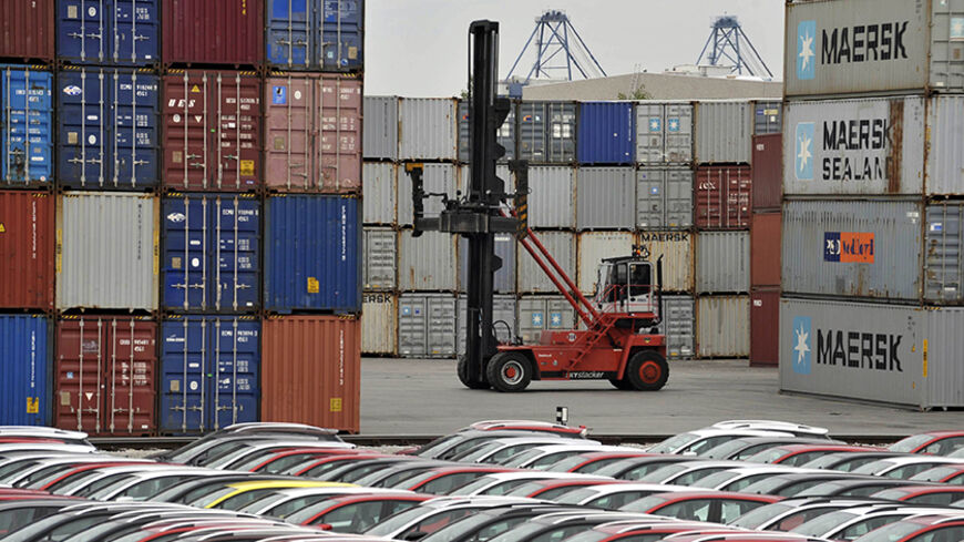 Renault cars produced in Turkey and awaiting export throughout Europe, are lined-up in front of ship containers in the port of Koper October 14, 2013. Automotive industry association ACEA said October 16, 2013, that new car registrations in Europe climbed 5.5 percent to 1.19 million vehicles in September, only the third month a gain was recorded in the past two years. But within the European Union, the level of demand was the second lowest on record for the month of September since it began tabulating resul