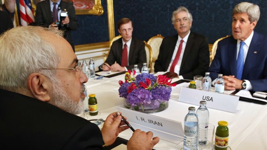 Iran's Foreign Minister Javad Zarif (L) holds a bilateral meeting with U.S. Secretary of State John Kerry (R) on the second straight day of talks over Tehran's nuclear program in Vienna, July 14, 2014. Kerry will press his Iranian counterpart Zarif to make "critical choices" in a second straight day of talks over Tehran's nuclear program on Monday, a U.S. official said. REUTERS/Jim Bourg (AUSTRIA - Tags: POLITICS ENERGY) - RTR3YJOV