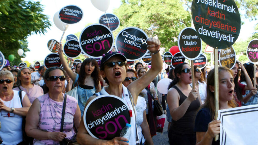Women hold signs as they take part in a demonstration against government plans to ban or limit the practice of abortion in Turkey, on June 17, 2012, in Ankara. Some of the signs read "End the killing of women". A majority of Turks oppose a ban on abortion as the Islamist-rooted government moves to try and limit the practice, according to a survey published on June 11. A total of 55.5 percent said they opposed a ban, while the remaining 44.5 percent were for it, according to the Konsensus research centre pol