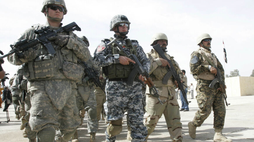 Military personnel and policemen march during a parade for their graduation ceremony in Kirkuk, 250 km (155 miles) north of Baghdad February 15, 2010. The "Golden Lions", a mixed squad consisting of U.S. military personnel, Iraqi and Peshmerga soldiers as well as policemen graduated from the academy in Kirkuk after finishing a month of training on Monday, police official said.     REUTERS/Ako Rasheed (IRAQ - Tags: MILITARY POLITICS) - RTR2AAYS