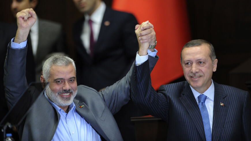 Turkey's Prime Minister Recep Tayyip Erdogan (R) and Hamas' Gaza leader Ismail Haniyeh greet members of parliament from Erdogan's ruling AK Party (AKP) during a meeting at the Turkish parliament in Ankara January 3, 2012. REUTERS/Stringer (TURKEY - Tags: POLITICS) - RTR2VUBV