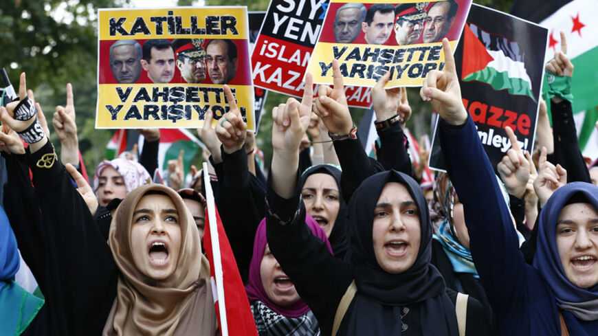 Pro-Palestinian demonstrators shout slogans as they protest against Israel's military action in Gaza, after Friday prayers at the courtyard of Fatih mosque in Istanbul July 18, 2014. Israel stepped up its land offensive in the Gaza Strip with artillery, tanks and gunboats on Friday after Islamist militants there rejected a proposed truce and kept firing rockets into the Jewish state. The banner reads, "Killers compete on savagery". REUTERS/Murad Sezer (TURKEY - Tags: POLITICS CIVIL UNREST) - RTR3Z81C
