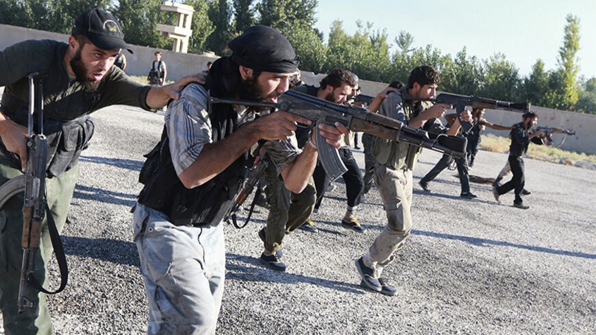Rebel fighters demonstrate their skill with their weapons during a military display as part of a graduation ceremony at a camp in eastern al-Ghouta, near Damascus September 4, 2014. The newly graduated rebel fighters, who went through military training, will join the "Al-Habib al-Mustafa" Brigades. REUTERS/Bassam Khabieh (SYRIA - Tags: POLITICS CIVIL UNREST CONFLICT) - RTR44WPX
