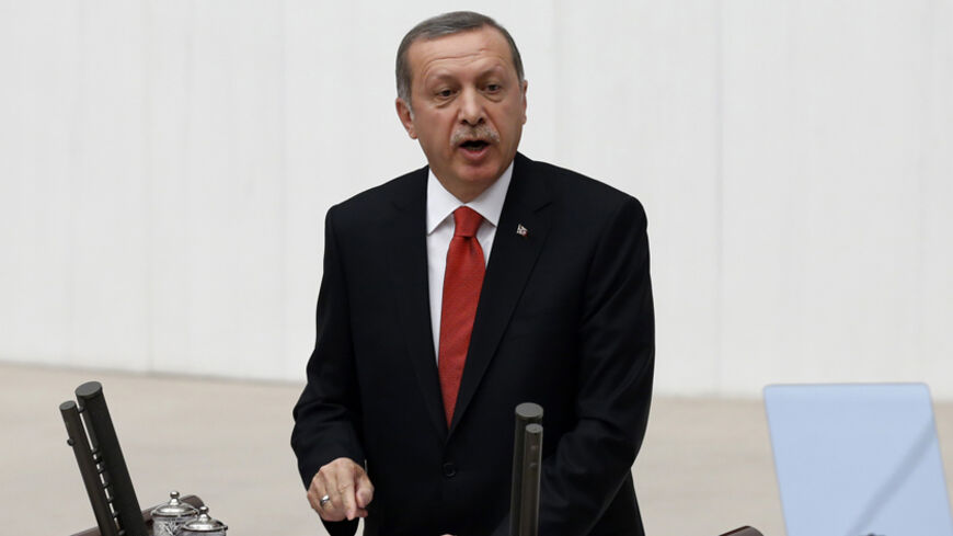 Turkey's President Tayyip Erdogan addresses the Turkish Parliament during a debate marking the reconvene of the parliament in Ankara October 1, 2014. Turkey will fight against Islamic State and other "terrorist" groups in the region but will stick to its aim of seeing Syrian President Bashar al-Assad removed from power, Erdogan said on Wednesday. REUTERS/Umit Bektas (TURKEY - Tags: POLITICS) - RTR48IMI