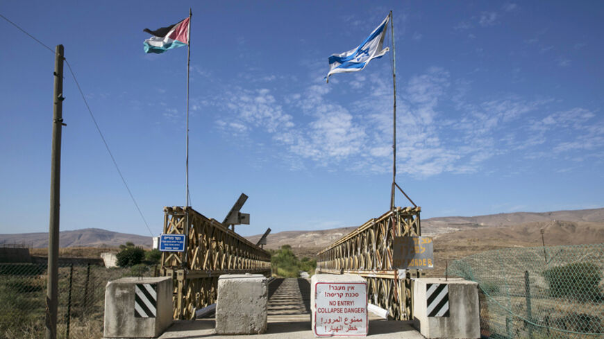 National Jordanian and Israeli flags are seen on the Naharayim bridge on the border between Israel and Jordan north-eastern Israel October 22, 2014. With attacks by Hezbollah from Lebanon, the threat from Islamic State and the Nusra Front in Syria and growing unrest in Egypt's Sinai, the north and south of Israel?s borders are on edge. By comparison, the eastern frontier with Jordan looks like an oasis of calm. Yet the Hashemite kingdom, wedged between Iraq, Syria and Saudi Arabia as well as Israel and the