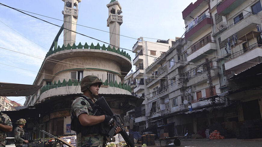 Lebanese army soldiers patrol the Sunni Muslim Bab al-Tebbaneh neighbourhood after being deployed to tighten security, following clashes between Lebanese soldiers and Islamist gunmen, October 27, 2014. The Lebanese army took ground from Islamist gunmen in the northern city of Tripoli on Monday, security sources and a witness said, after weekend fighting in which 11 soldiers and eight civilians were killed. REUTERS/Stringer   (LEBANON - Tags: CIVIL UNREST MILITARY) - RTR4BQ8R