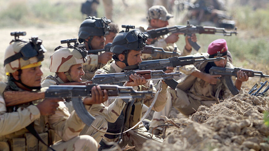 Iraqi Army personnel take part during an intensive security deployment against Islamic State militants in Jurf al-Sakhar October 27, 2014. Picture taken October 27, 2014. REUTERS/Mahmoud Raouf Mahmoud (IRAQ - Tags: CIVIL UNREST POLITICS MILITARY TPX IMAGES OF THE DAY) - RTR4BVO5