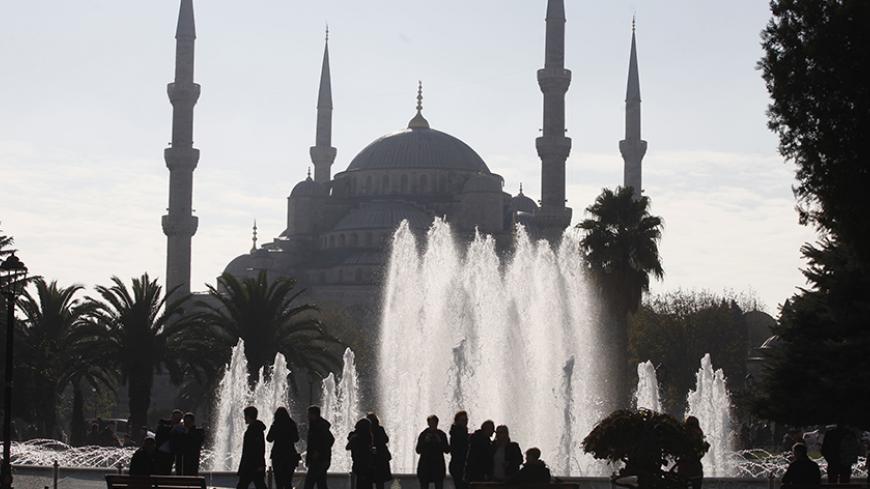 People walk past the Ottoman-era Suleymaniye Mosque in Istanbul November 28, 2014. Pope Francis begins a visit to Turkey on Friday with the delicate mission of strengthening ties with Muslim leaders while condemning violence against Christians and other minorities in the Middle East. REUTERS/Osman Orsal (TURKEY - Tags: RELIGION) - RTR4FZ43