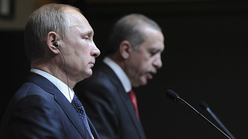 Russia's President Vladimir Putin (L) is pictured during a joint news conference with his Turkish counterpart Tayyip Erdogan in Ankara December 1, 2014. Putin said on Monday that Moscow could not carry on with the South Stream project if the European Union was opposed to it. Speaking at a joint news conference with Turkish President Erdogan, Putin said the European Commission was reluctant to give the green light to the South Stream project. REUTERS/Mikhail Klimentyev/RIA Novosti/Kremlin (TURKEY - Tags: PO