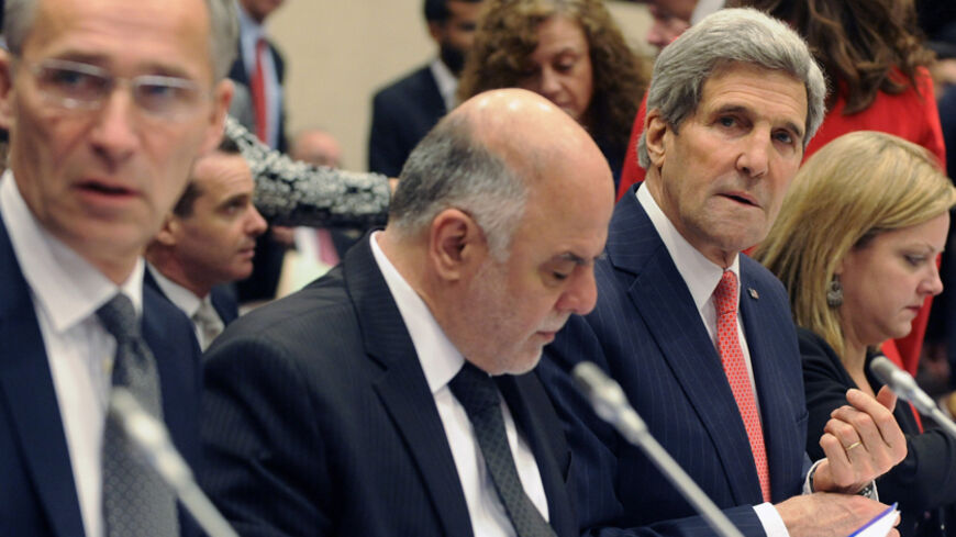 NATO Secretary General Jens Stoltenberg (L) Iraqi Prime Minister Haider al-Abadi (CL) and U.S. Secretary of State John Kerry (CR) attend a round table meeting of the global coalition to counter the Islamic State militant group at NATO headquarters in Brussels December 3, 2014. REUTERS/Eric Vidal (BELGIUM - Tags: POLITICS CIVIL UNREST) - RTR4GIZ7