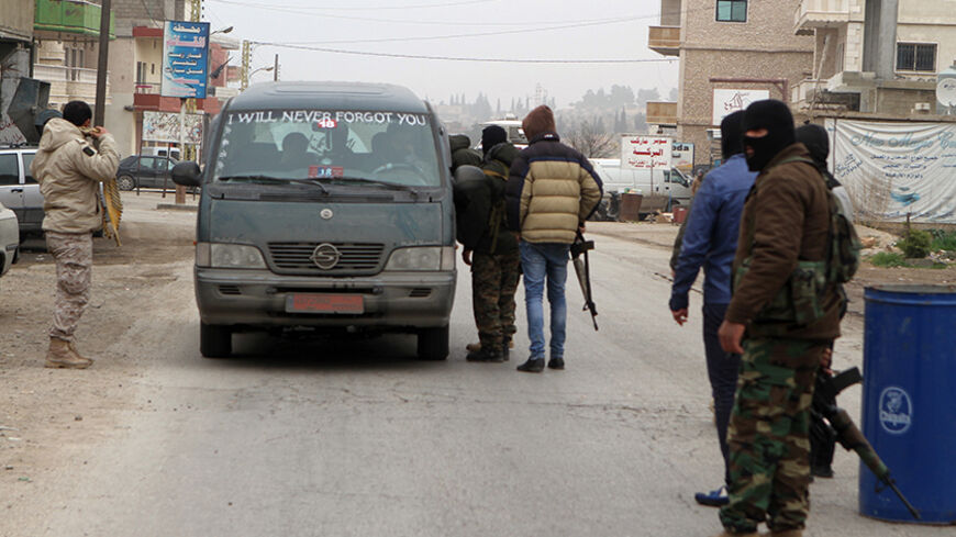 Masked gunmen man a checkpoint in Bazalia village, home of Lebanese soldier Ali al-Bazzal who was killed by Nusra Front, on a road that links Arsal to Baalbek December 6, 2014. Syria's al Qaeda offshoot Nusra said on Friday it killed captive Lebanese soldier al-Bazzal in retaliation for the arrest by Lebanese authorities of women identified as wives of Islamist militants. The soldier was one of more than two dozen members of the security forces taken captive by militants affiliated to the Nusra Front and Is