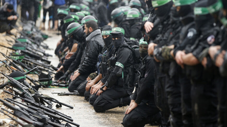 Palestinian members of al-Qassam Brigades, the armed wing of the Hamas movement, pray before a military parade marking the 27th anniversary of Hamas' founding, in Gaza City December 14, 2014.  REUTERS/Mohammed Salem (GAZA - Tags: POLITICS MILITARY ANNIVERSARY RELIGION) - RTR4HY0R