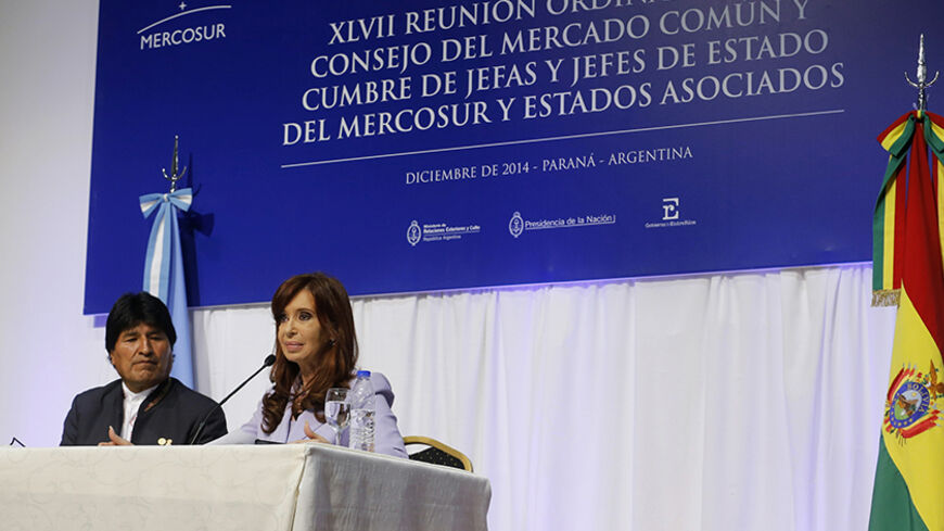 Bolivia's President Evo Morales (L) and his Argentine counterpart Cristina Fernandez de Kirchner attend a bilateral meeting after the Southern Common Market (MERCOSUR) trade bloc annual presidential 47th summit in Parana, north of Buenos Aires December 17, 2014. Argentina and Bolivia signed a commercial agreement on Argentine-assembled ambulances to be delivered to Bolivia. REUTERS/Enrique Marcarian (ARGENTINA - Tags: POLITICS) - RTR4IH3O