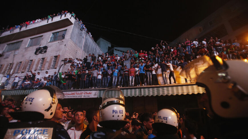Palestinians watch the result of "Arab Idol" in the West Bank city of Ramallah June 22, 2013. The 22-year-old singer Mohammed Assaf, from the Gaza Strip, was named the winner of "Arab Idol" in a TV talent contest in Beirut. REUTERS/Mohamad Torokman (WEST BANK - Tags: SOCIETY ENTERTAINMENT TPX IMAGES OF THE DAY) - RTX10XJ7
