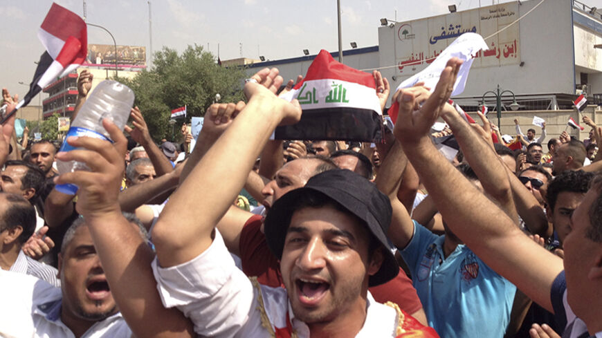 Protesters demand that the pensions of parliamentarians be cancelled during a demonstration in Baghdad August 31, 2013. Thousands are rallying across Iraq against corruption and the financial privileges of lawmakers and political leaders. REUTERS/Thaier al-Sudani (IRAQ - Tags - Tags: POLITICS BUSINESS EMPLOYMENT CIVIL UNREST) - RTX132IA