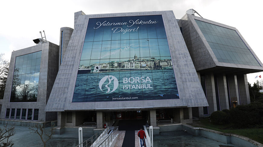 A man enters the Bourse Istanbul in Istanbul December 17, 2013. Turkey's Bourse Istanbul could acquire a minority stake in Nasdaq OMX Group as part of a tie-up that will involve the Turkish exchange using Nasdaq's market technologies, its chairman Ibrahim Turhan said on December 31, 2013. Bourse Istanbul will buy stock trading and clearing software and infrastructure from Nasdaq OMX and will be able to use and resell the software in 25 countries, in a move designed to attract more trade from the world's lea