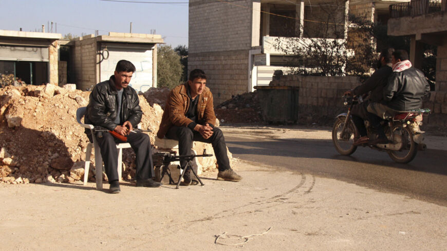 Free Syrian Army fighters man a checkpoint to prevent kidnapping, activists said, in Kafranbel, Idlib province February 7, 2014. Picture taken February 7, 2014. REUTERS/Fadi Mashan (SYRIA - Tags: POLITICS CIVIL UNREST CONFLICT) - RTX18FIK