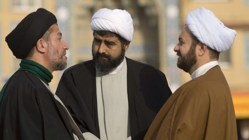 Clerics speak on the campus of the Seminary in Qom, 120 km (75 miles) south of Tehran February 3, 2009. REUTERS/Caren Firouz  (IRAN) - RTXB72L