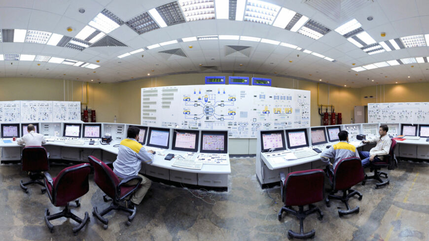 EDITORS' NOTE: Reuters and other foreign media are subject to Iranian restrictions on their ability to film or take pictures in Tehran.

Russian (L and R) and Iranian operators monitor the nuclear power plant unit in Bushehr, about 1,215 km (755 miles) south of Tehran, November 30, 2009. Russia plans to start up Iran's first nuclear power station in March 2010 to coincide with the Iranian New Year, two sources closely involved with the project told Reuters. Russia agreed in 1995 to build the 1,000 megawatt 