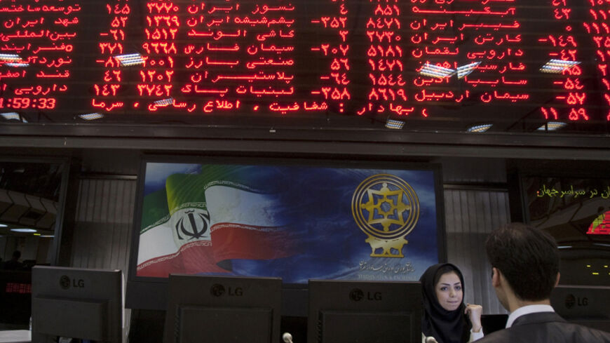 EDITORS' NOTE: Reuters and other foreign media are subject to Iranian restrictions on their ability to report, film or take pictures in Tehran.
A trader speaks with a stock market official beneath the electronic board at the Tehran stock exchange September 15, 2010. While U.S. diplomats were busy upping Iran's economic punishment over nuclear activities Washington fears are aimed at making a bomb, Iranian shares, which might have been expected to fall, have, instead, gone through the roof. Picture taken S