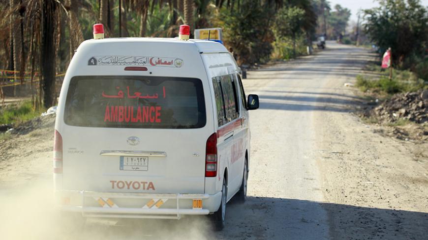 An Ambulance drives down a street in the Jurf al-Sakhr area, north of the Shiite shrine city of Karbala on October 26, 2014. Iraqi officials said that government forces backed by Shiite militias retook Jurf al-Sakhr, southwest of Baghdad, from Islamic State (IS) group militants on October 25. AFP PHOTO/HAIDAR HAMDANI        (Photo credit should read HAIDAR HAMDANI/AFP/Getty Images)