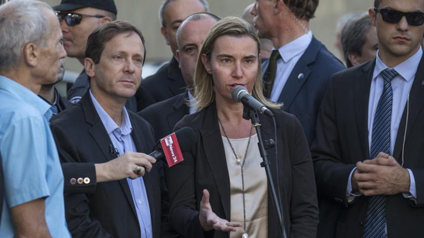 New High Representative of the European Union (EU) for Foreign Affairs and Security Policy, Federica Mogherini (C) gives a speech during a visit at the memorial site where late Israeli prime minister Yitzhak Rabin was assassinated, in November 1995, in the Israeli Mediterranean coastal city of Tel Aviv on November 7, 2014. Mogherini is on an official visit to Israel and the Palestinian territories during which she has held talks with officials from both sides. AFP PHOTO / JACK GUEZ        (Photo credit shou