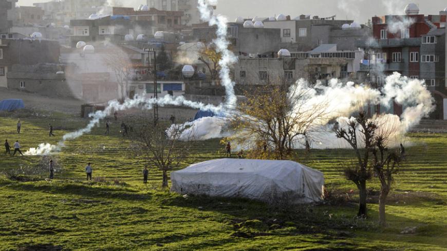 Kurdish people clash with Turkish police on December 29, 2014, at Cizre in Sirnak. Tensions ran high in the southeastern town of Cizre early on December 27 following armed clashes between members of the Patriotic Revolutionist Youth Movement (YDG-H), an affiliate of the Kurdistan Workers' Party (PKK) and Huda-Par, a Kurdish Sunni Islamist party. AFP PHOTO/ILYAS AKENGIN        (Photo credit should read ILYAS AKENGIN/AFP/Getty Images)
