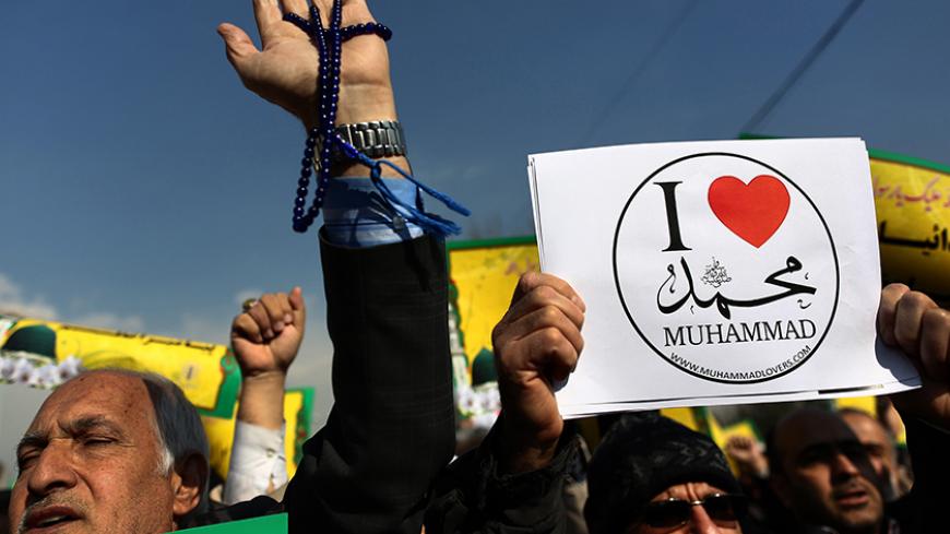 Iranian worshippers demonstrate after the weekly Friday prayers on January 23, 2015 in Tehran to protest against a cartoon of the Prophet Mohammed that was published by the French satirical magazine Charlie Hebdo in an edition issued a week after 12 people were killed by Islamist gunmen at its Paris offices. Iran denounced the attack on the offices of Charlie Hebdo but has also condemned as "insulting" and "provocative" its publication last week of a new cartoon of the Prophet Mohammed.  AFP PHOTO/BEHROUZ M