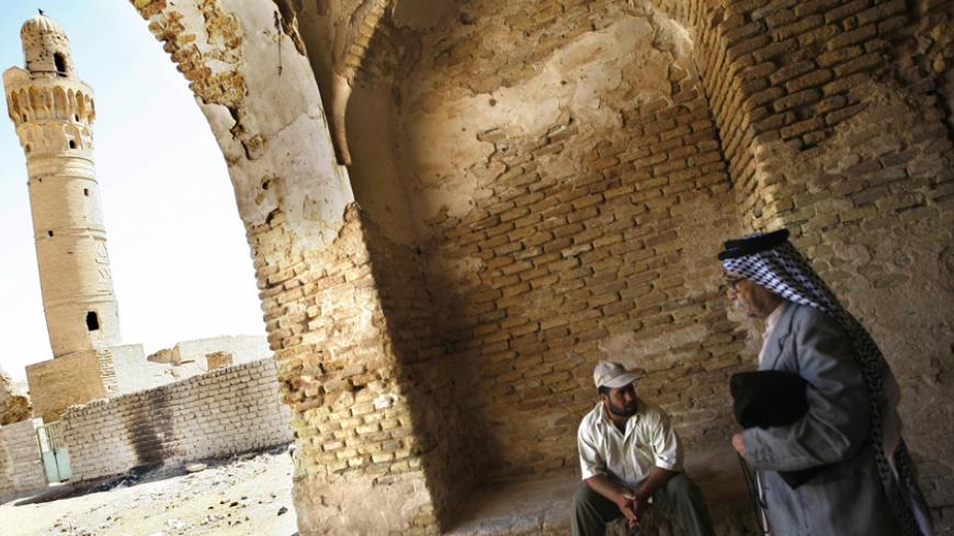 TO GO WITH STORY BY JOSEPH KRAUSS An Iraqi man leaves an indoor market as he walks towards the 14th-century brick minaret of the Dhu al-Kifl mosque at the site of the Jewish shrine of Ezekiel -- the prophet who followed the Judeans into the Babylonian exile in the 6th century BC -- in the Iraqi town of Kifl, south of Baghdad. Muslims revere nearly all the central religious figures from Judaism and Christianity, including Ezekiel, referred to as Dhu al-Kifl in two Koranic verses and said to have raised the