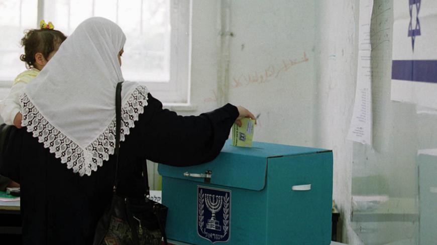 An Israeli-Arab voter drops a ballot into a ballot box during voting in East Jerusalem, February 6, 2001. Most Israeli-Arabs are expected to abstain from voting in a protest against the 13 Israeli-Arabs who were killed during the recent 'Intifada' or uprising against Israel. Ariel Sharon appeared poised for a stunning political victory over Prime Minister Ehud Barak as voters began casting ballots Tuesday in an election seen as a referendum on Israel's relationship with the Palestinians.
EH/WS - RTR15LTJ