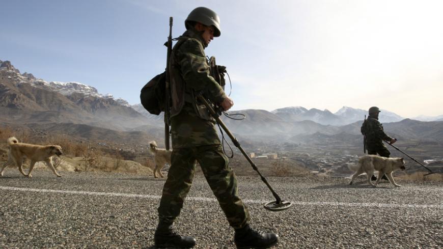 Turkish soldiers use mine detectors to search for landmines during a patrol on a road outside the south-eastern Turkish town of Sirnak bordering northern Iraq February 24, 2008. Turkey began sending thousands of ground troops across the mountainous border into northern Iraq on Thursday to crush PKK guerrillas who use the region as a base from which to attack targets inside Turkey.   REUTERS/Fatih Saribas  (TURKEY) - RTR1XHU0