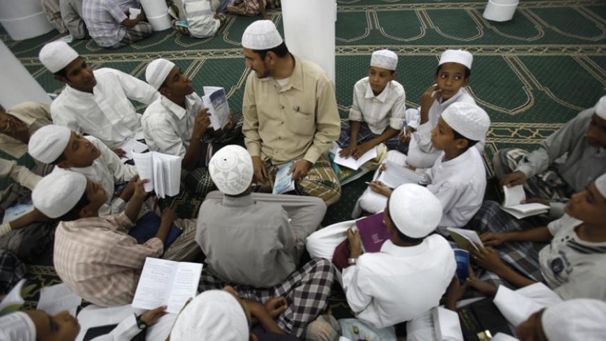 Students attend a traditional Sufi "halaqa" (study group) at the Ribat Tarim religious school in the historical city of Tarim in southeastern Yemen February 23, 2010. Tarim has long been a teaching centre for Sufism, a mystical strand in Islam, but all Islamic schools have come under scrutiny since al Qaeda in Yemen said it was behind a failed attack on a U.S.-bound jet on Dec. 25.  Picture taken on February 23, 2010. To match feature YEMEN-RELIGION/    REUTERS/Khaled Abdullah (YEMEN - Tags: RELIGION EDUCAT
