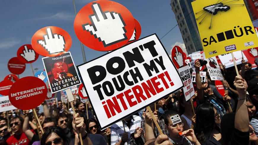 Demonstrators hold placards with some featuring a picture of Turkey's Prime Minister Tayyip Erdogan during a protest against internet censorship in Istanbul May 15, 2011. Thousands of people marched in central Istanbul to protest against the government's plan to filter the internet. REUTERS/Murad Sezer (TURKEY - Tags: CIVIL UNREST POLITICS) TEMPLATE OUT - RTR2MG6Y