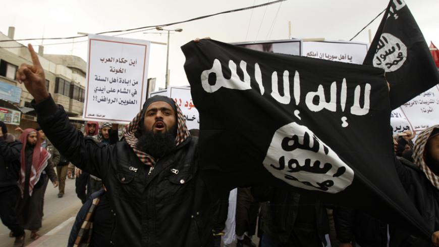 Palestinian Salafists take part in a protest against Syria's President Bashar al-Assad in Rafah in the southern Gaza Strip February 24, 2012. The black flag reads "There is no god but Allah and Mohammad is the prophet". The white sign reads "Where are the traitor Arab rulers". REUTERS/Ibraheem Abu Mustafa (GAZA - Tags: POLITICS CIVIL UNREST) - RTR2YDGR