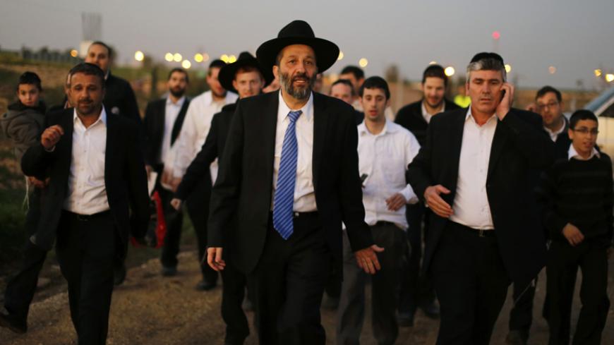 Aryeh Deri (C), leader of the ultra-Orthodox Shas party, attends an annual pilgrimage to the gravesite of Rabbi Yisrael Abuhatzeira, a Moroccan-born sage and kabbalist also known as the Baba Sali, in the southern town of Netivot January 14, 2013.  Powerful political players for years, Israel's ultra-Orthodox parties must now reckon with a new force ushered in by voters bent on stripping them of perks they have relied on for decades. Picture taken January 14, 2013. REUTERS/Amir Cohen (ISRAEL - Tags: POLITICS