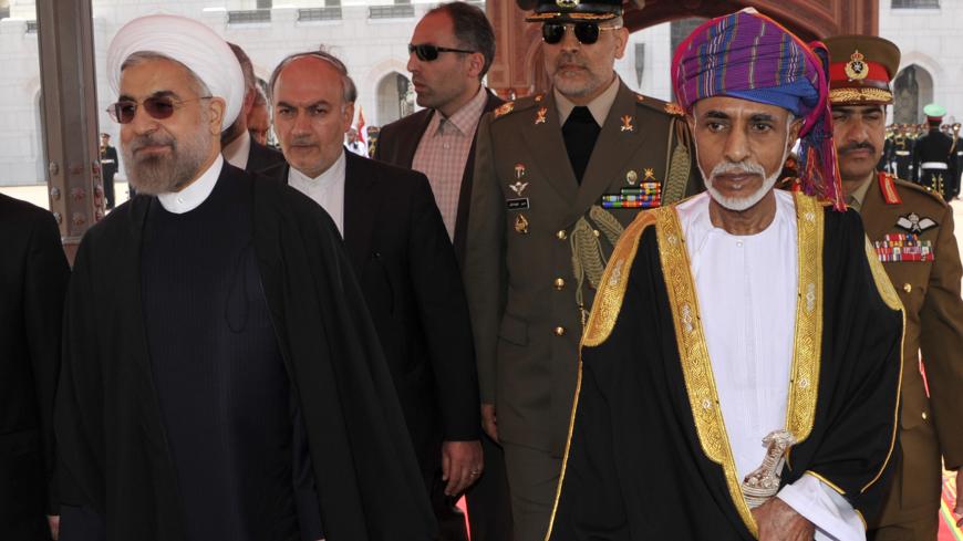 Oman's Sultan Qaboos bin Said (R) walks with Iran's President Hassan Rouhani upon Rouhani's arrival in Muscat March 12, 2014. REUTERS/Sultan Al Hasani (OMAN - Tags: POLITICS ROYALS) - RTR3GQAH
