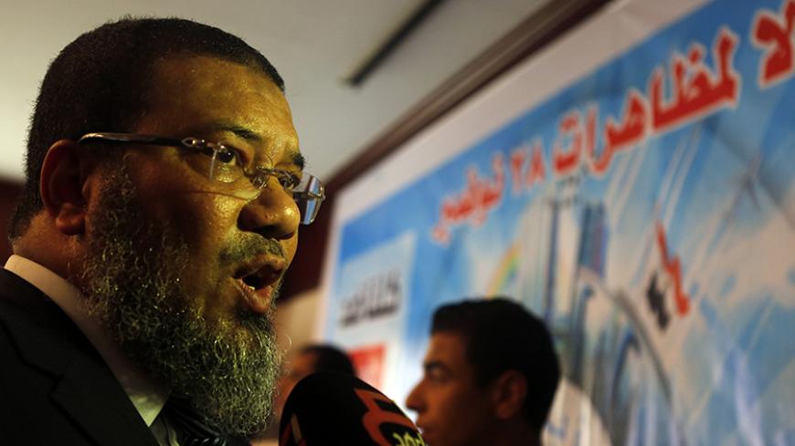 Ashraf Thabet, salafist leader and the Vice-President Al-Nour Party speaks to media after a news conference against the upcoming 28 November Islamic demonstrations in Cairo November 26, 2014. An ultra-conservative Salafi Islamist group in Egypt called the "Salafist Front" has called for protests on 28 November to "end military rule". The banner reads " No to demonstrations of 28 November". REUTERS/Amr Abdallah Dalsh  (EGYPT - Tags: POLITICS) - RTR4FO63
