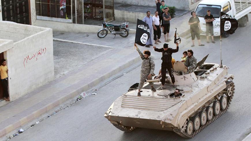 RNPS: YEAREND REVIEW 2014 - HEADLINE MAKERS

Militant Islamist fighters hold the flag of Islamic State (IS) while taking part in a military parade along the streets of northern Raqqa province in this June 30, 2014 file photo. 2014 saw the rise of the Sunni militant group Islamic State, which has seized swathes of territory in both Syria and Iraq.   REUTERS/Stringer (SYRIA - Tags: POLITICS CIVIL UNREST CONFLICT TPX IMAGES OF THE DAY) - RTR4IIGL